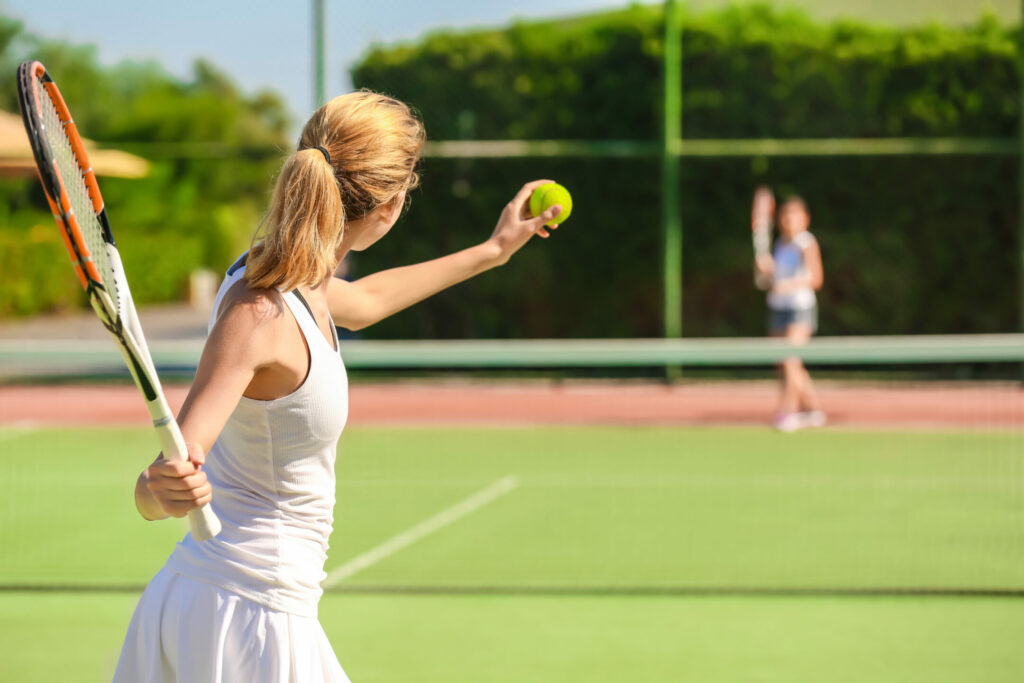 A tennis player gets ready to serve the ball, which may cause a SLAP-type tear. 
