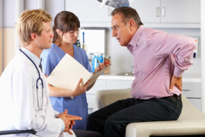 A spine specialist talks to a patient about his chronic pain.