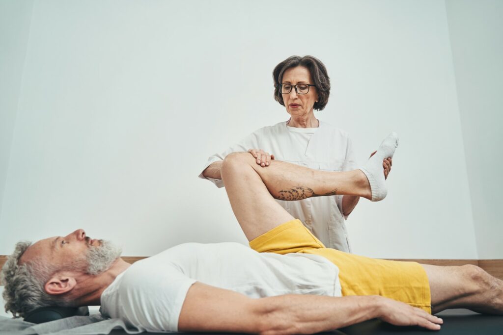 A medical specialist helps a patient with hip rotation to assist with hip flexor pain.